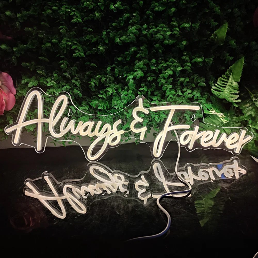 A imagem apresenta uma placa de LED neon brilhante exibindo as palavras "Always Forever" em uma escrita cursiva elegante.