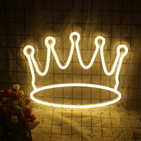 A vibrant LED neon sign shaped like a crown, featuring sleek, elegant lines and a luminous glow.