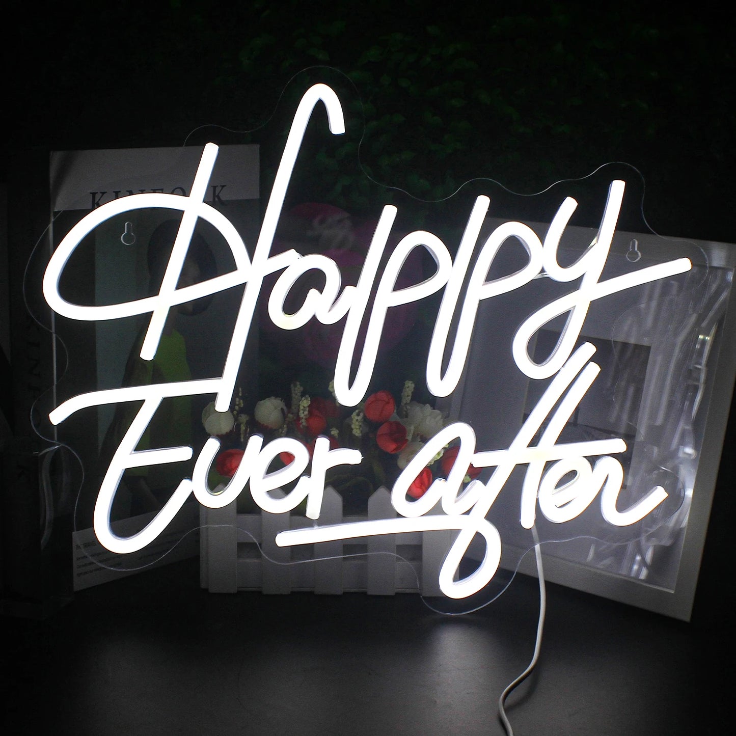 A vibrant LED neon sign spells out the phrase "Happy Ever After" in elegant, cursive lettering.