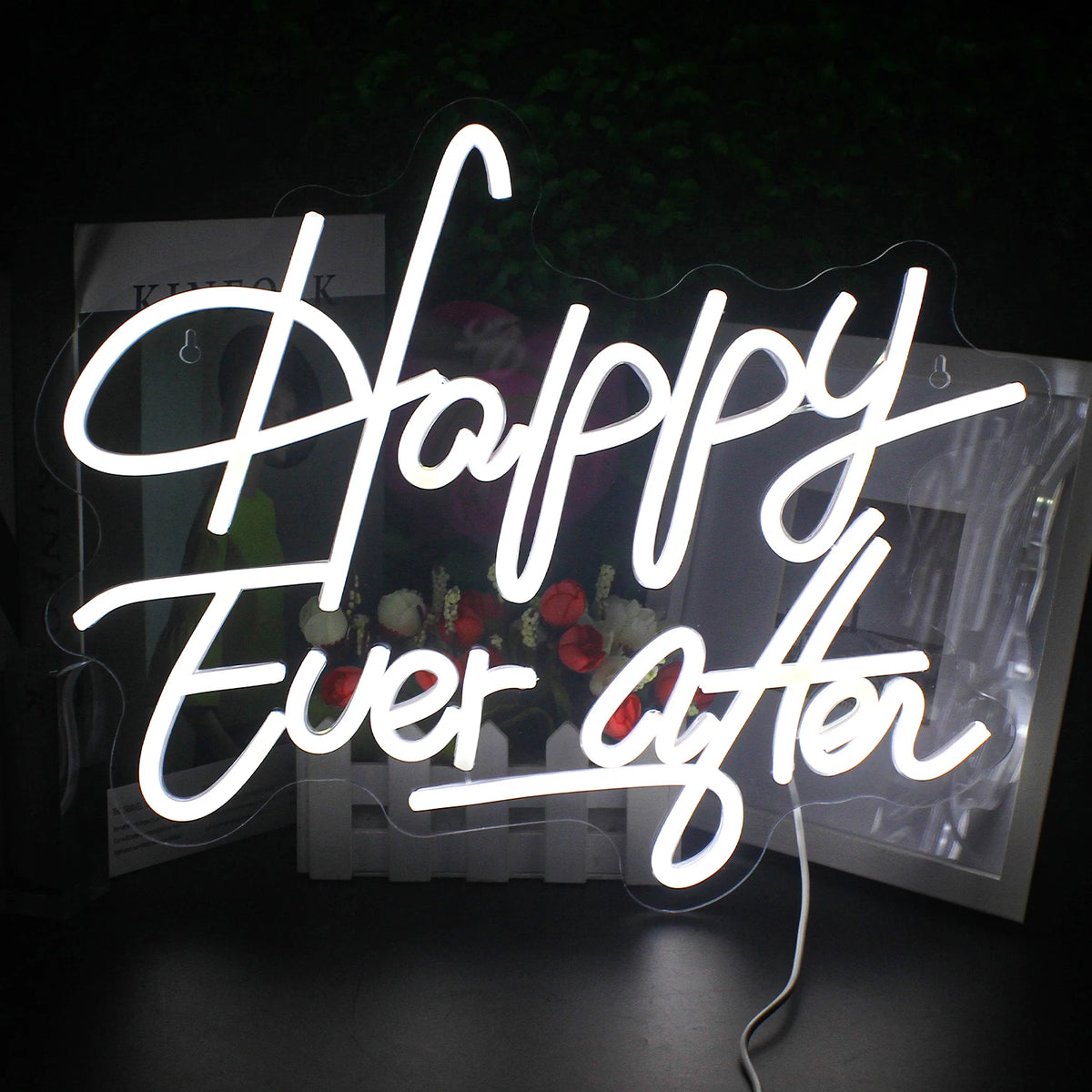A vibrant LED neon sign spells out the phrase "Happy Ever After" in elegant, cursive lettering.