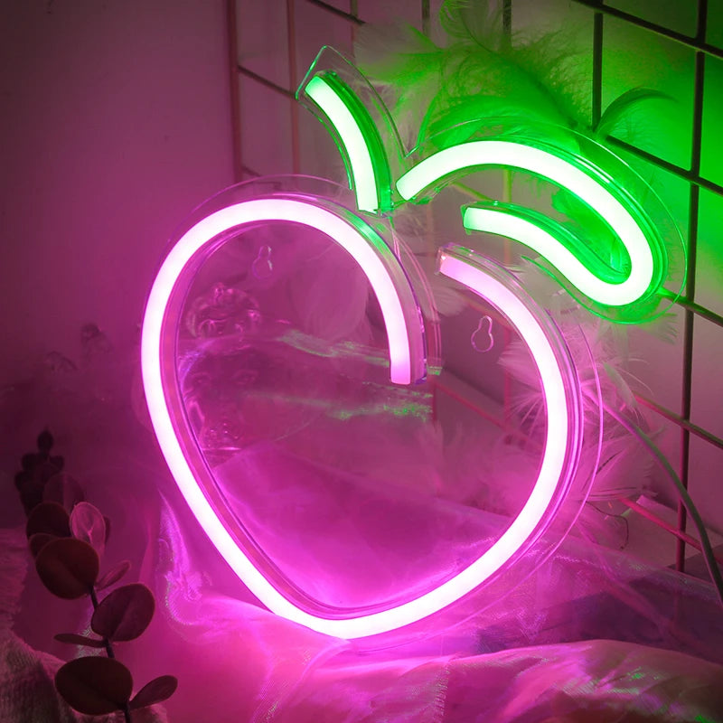 A stylishly designed Peach LED Neon Sign illuminates with a soft, warm glow.
