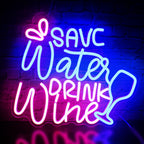 The image features a vibrant LED neon sign displaying the phrase "Save Water Drink Wine" in a stylish and playful font.