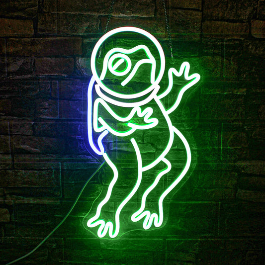 Image shows a vibrant, handmade LED neon sign in the shape of a frog, glowing with a bright green light.
