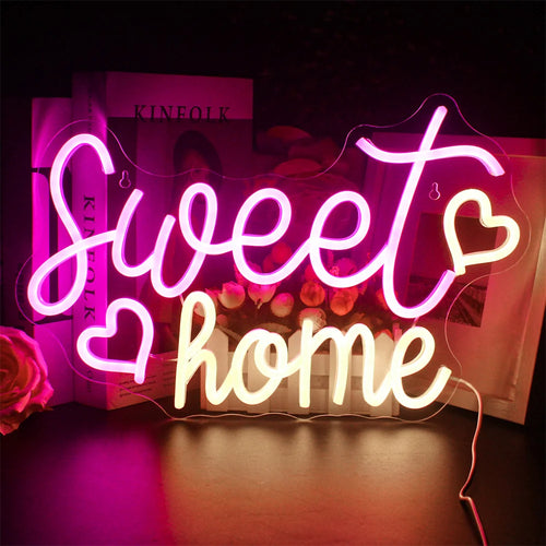 A imagem apresenta uma vibrante placa de LED neon feita à mão exibindo as palavras "Sweet Home" em uma escrita cursiva estilosa.