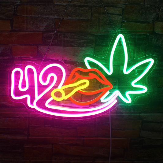 The image features a handmade LED neon sign depicting a vibrant green leaf accompanied by a stylized cigar graphic.