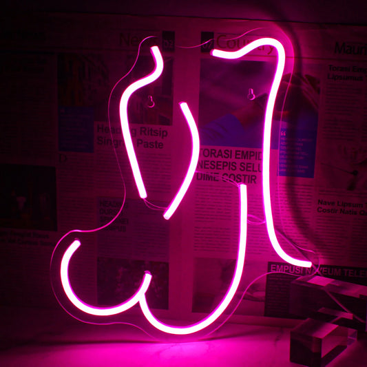 A vibrant pink LED neon sign shaped like a stylized outline of a woman in a reclining position.