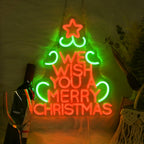 A imagem apresenta uma vibrante placa de LED neon exibindo as palavras "Desejamos a você um Feliz Natal" em uma fonte festiva e cursiva.