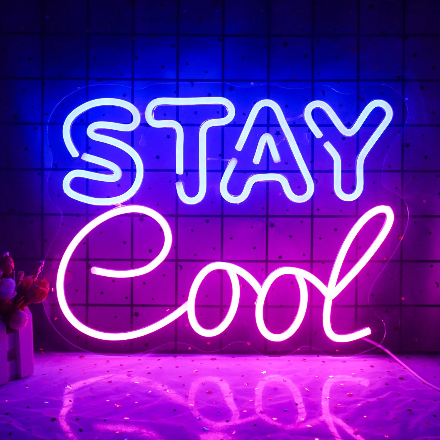 A vibrant "Stay Cool" LED neon sign is displayed, featuring bold, cursive lettering.