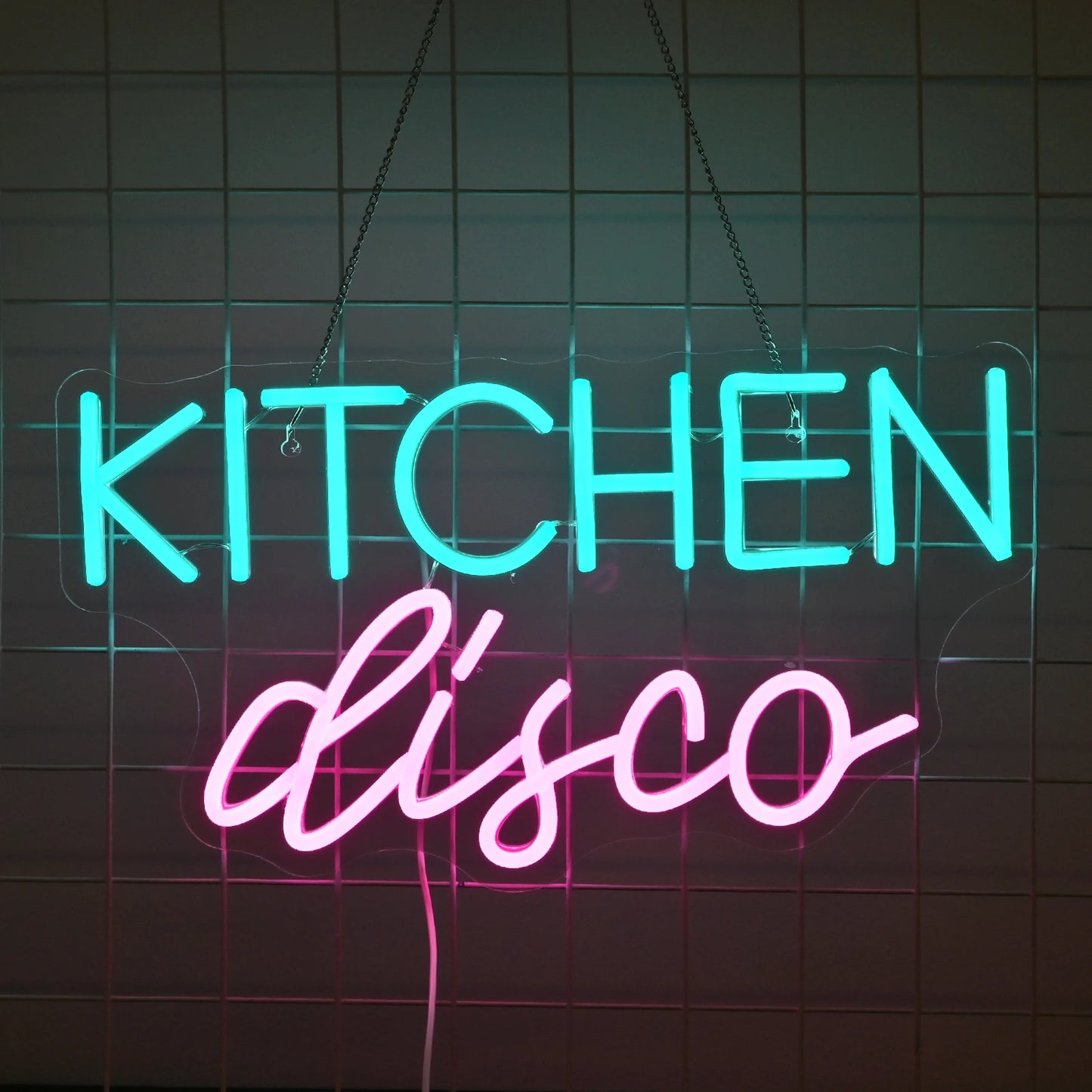 The image features a vibrant LED neon sign that reads "Kitchen Disco" in playful, cursive lettering.