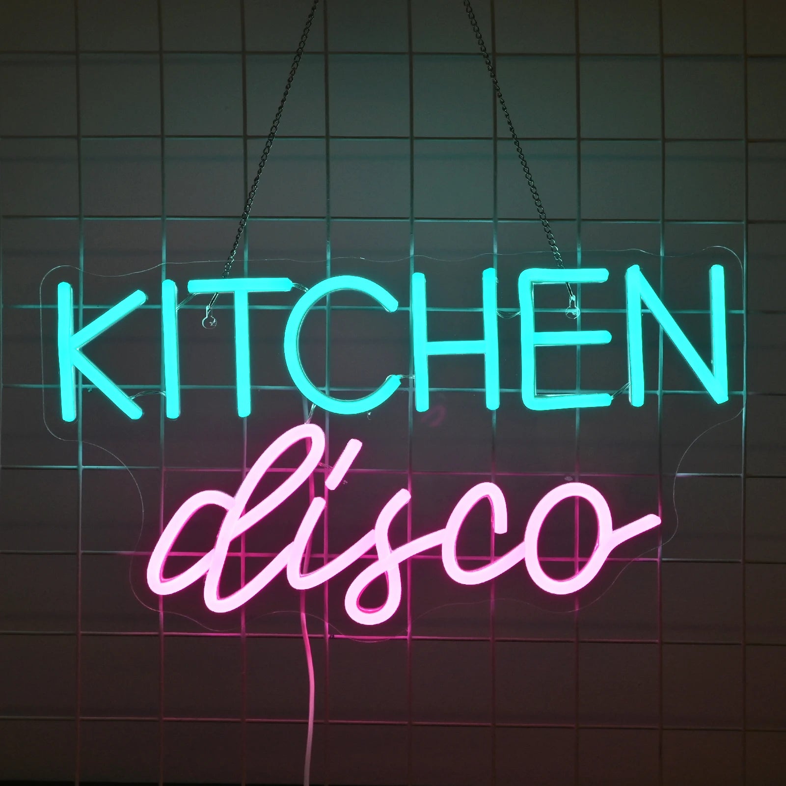 The image features a vibrant LED neon sign that reads "Kitchen Disco" in playful, cursive lettering.