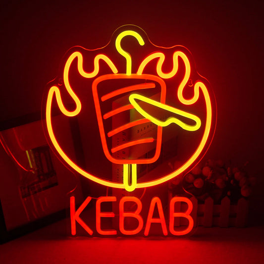 The image displays a vibrant LED neon sign in the shape of a kebab skewer.