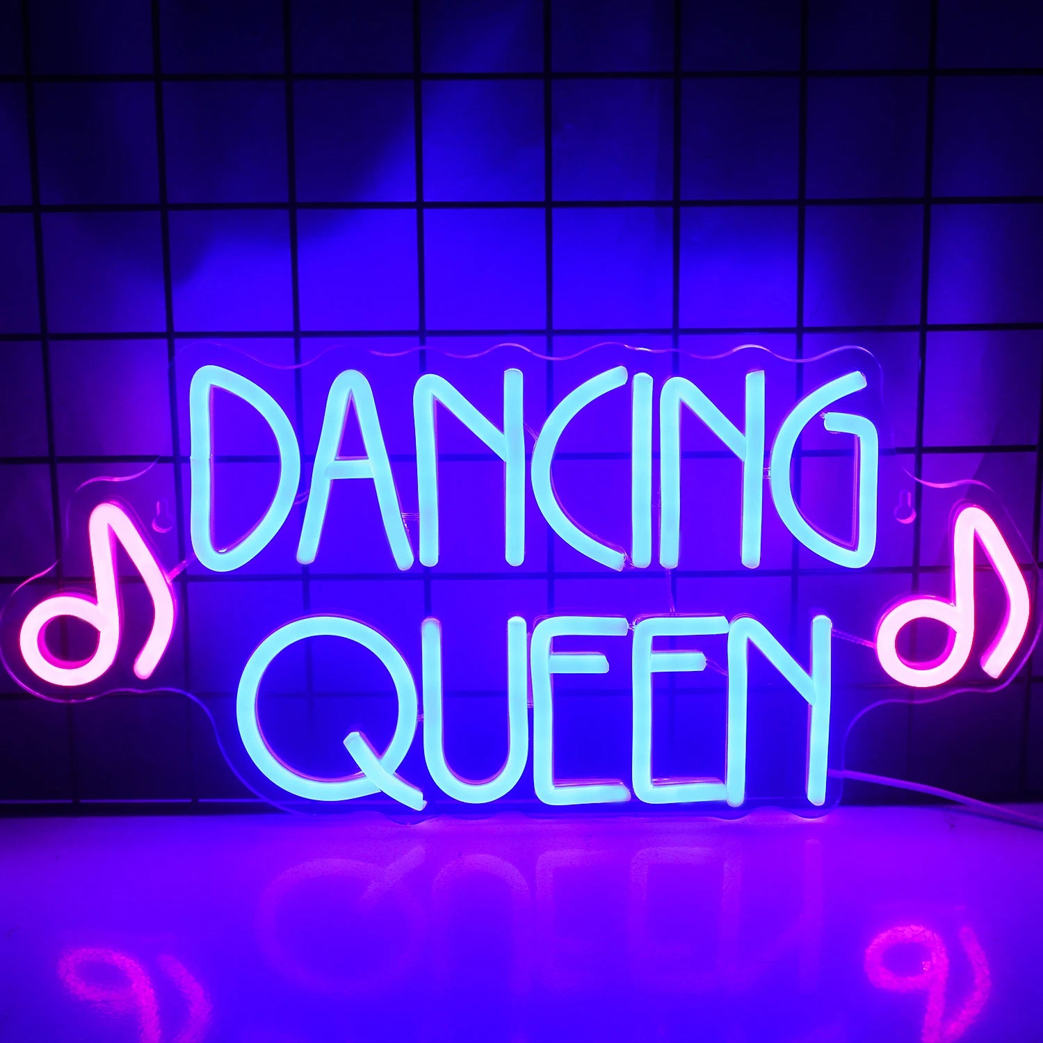 A vibrant LED neon sign displaying the words "Dancing Queen" in bold, flowing script.