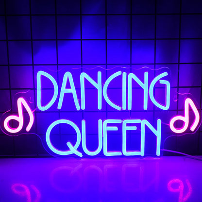 A vibrant LED neon sign displaying the words "Dancing Queen" in bold, flowing script.