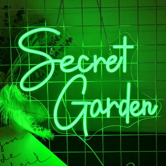 A vibrant LED neon sign featuring the words "Secret Garden" in elegant, cursive lettering.