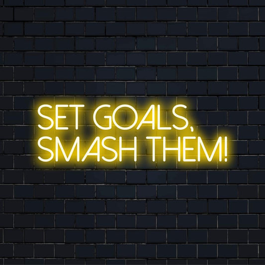 Set Goals, Smash Them! in bold LED light. Ideal neon decor for motivation, featuring bright and empowering words.
