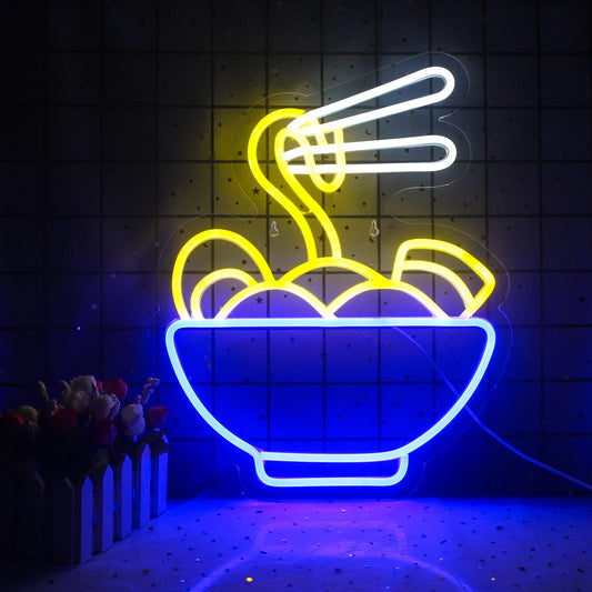 The image features a vibrant LED neon sign showcasing the word "Ramen" in bold, stylized letters.