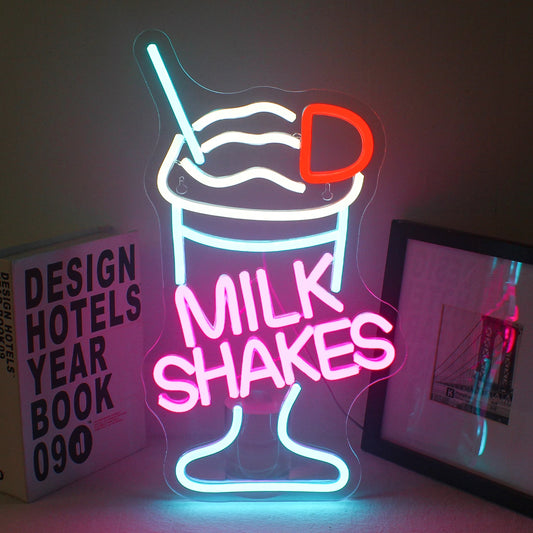 The image features a vibrant LED neon sign in the shape of a milkshake.