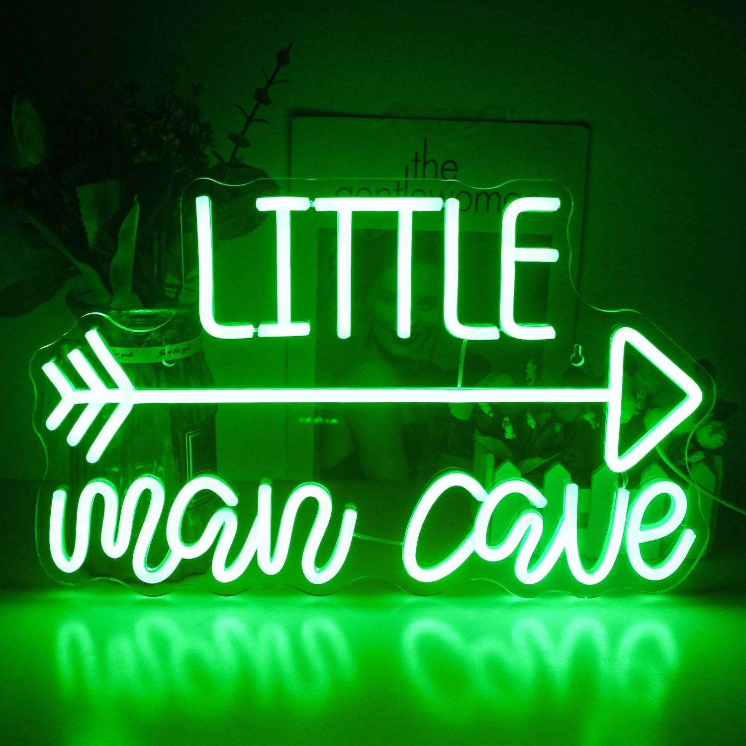 The image features a vibrant LED neon sign displaying the words "Man Cave" in bold, colorful letters.