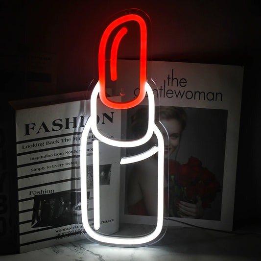 The image displays a vibrant, handmade LED neon sign in the shape of a lipstick.