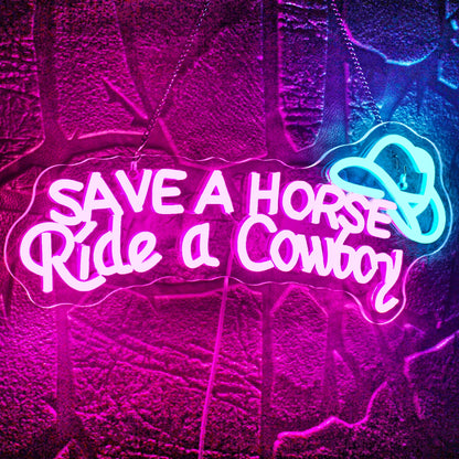The image displays a vibrant LED neon sign that reads "Save A Horse Ride a Cowboy" in a fun, playful script.