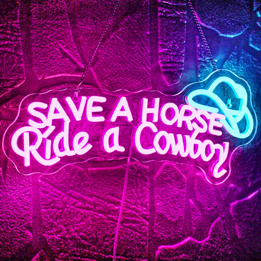 The image displays a vibrant LED neon sign that reads "Save A Horse Ride a Cowboy" in a fun, playful script.