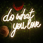 The image features a vibrant LED neon sign displaying the motivational phrase "Do What You Love" in bold, cursive lettering.