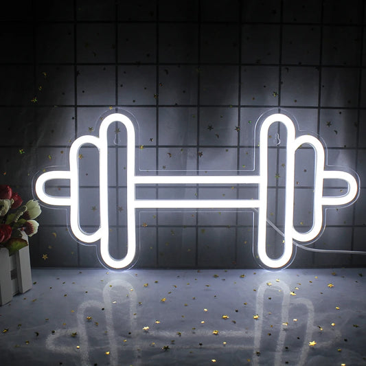 A vibrant LED neon sign shaped like a barbell, glowing in a striking combination of bright colors.