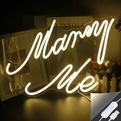 A "Marry Me" LED neon sign is shown, glowing brightly in a warm white hue.