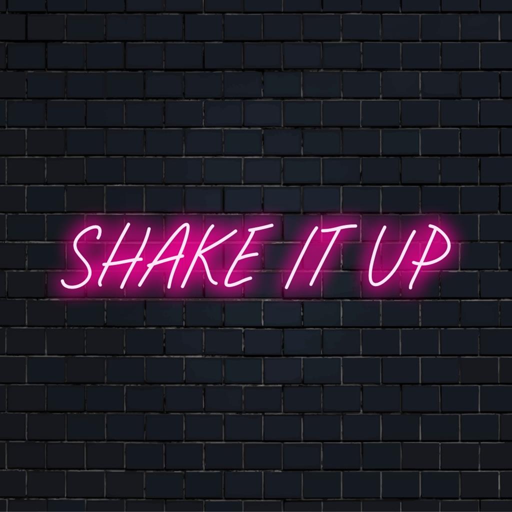 Placa de LED neon laranja e rosa energética com as palavras Shake It Up, representando energia vibrante e espírito de festa.