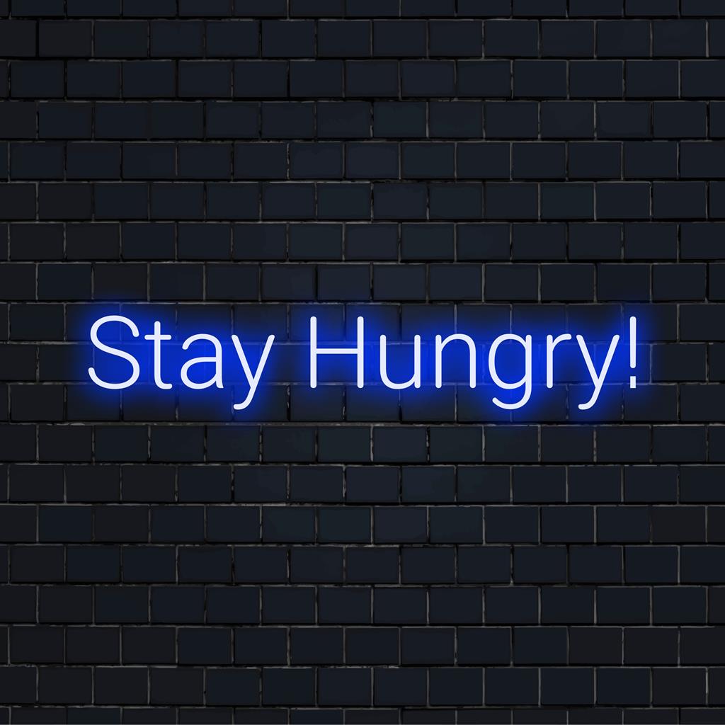 Letreiro de LED neon personalizado "Fique com fome!" com cores vibrantes e um brilho motivacional, ideal para uma decoração neon personalizada.