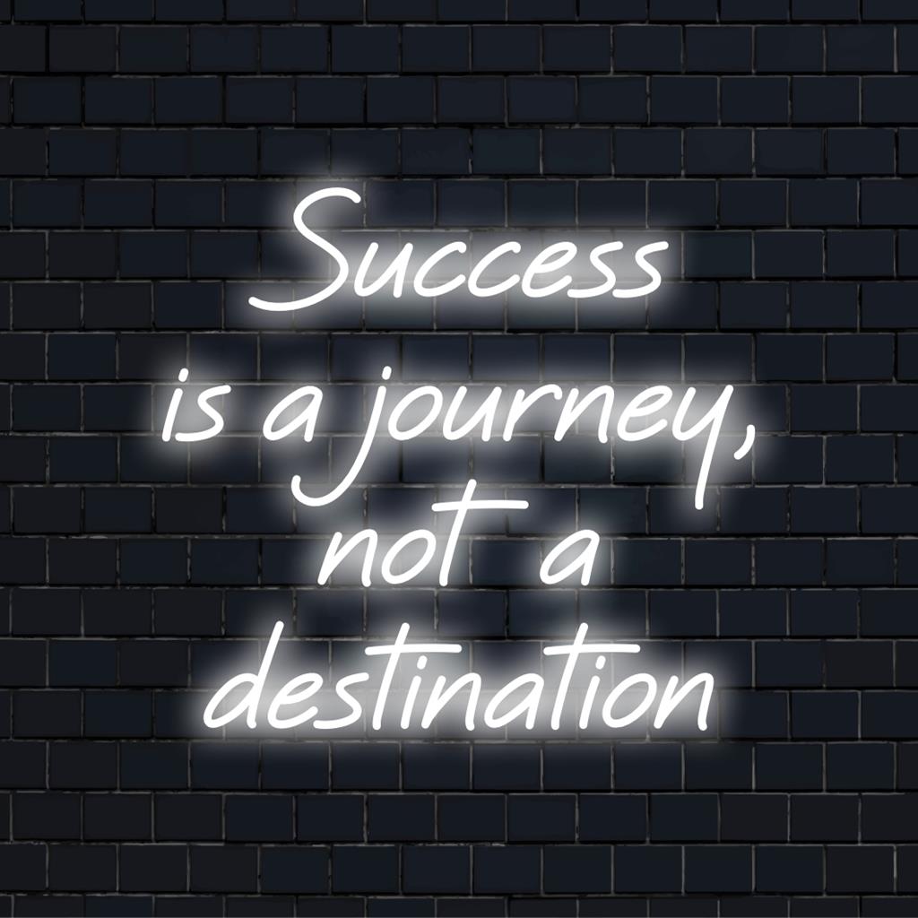 Custom LED neon sign illuminating the phrase Success Is A Journey, Not A Destination in bright artistic neon typography.
