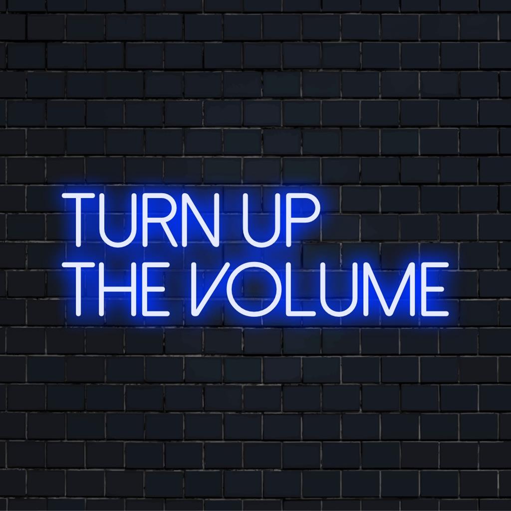 Custom-made LED neon sign reading Turn Up The Volume; perfect blend of vibrant neon art and statement decor.