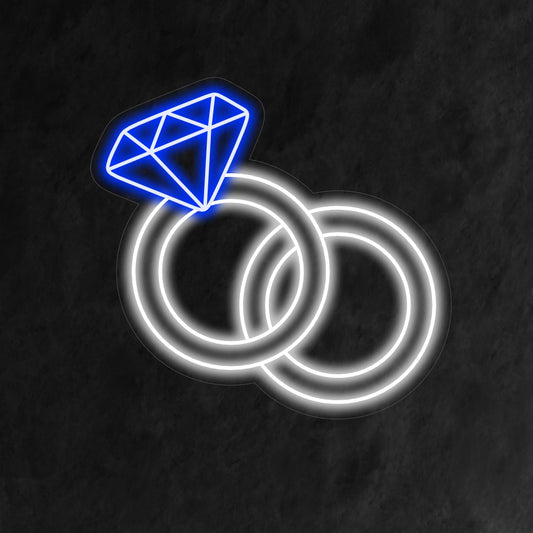 "Wedding Rings Neon Sign" symbolizes eternal love with a soft glow, creating a romantic atmosphere that celebrates the union of two hearts.