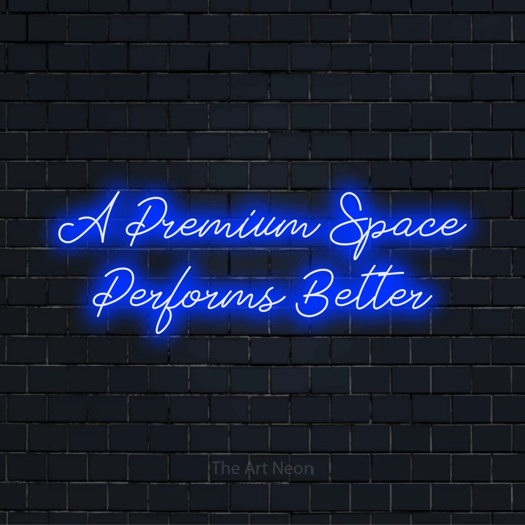 "A Premium Space Performs Better" glowing LED neon sign on a black brick wall