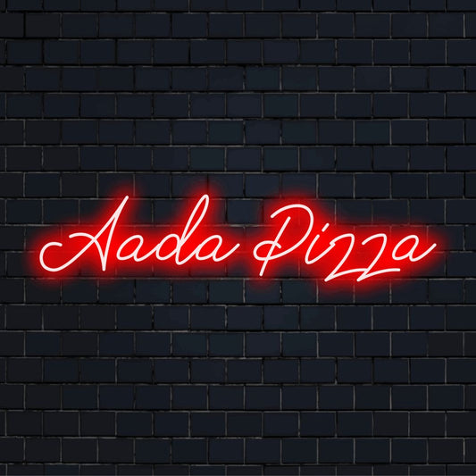 Aada Pizza Personalized Neon Light with bright neon glow against black brick wall