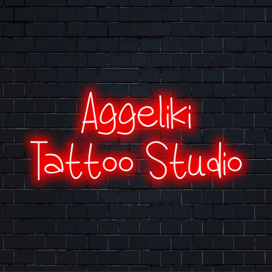 Aggeliki Tattoo Studio Personalized Neon Light with glowing neon text on black brick background