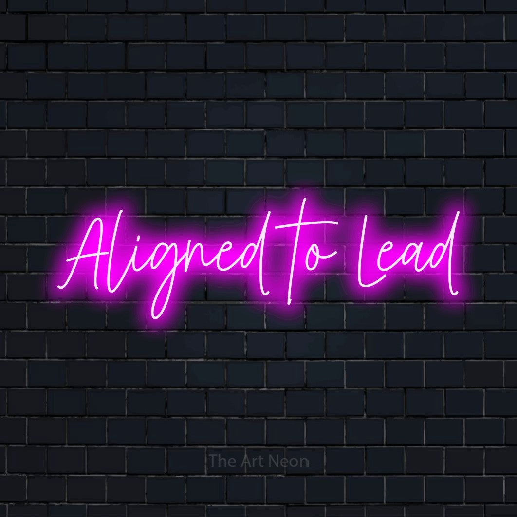 "Aligned To Lead" glowing LED neon sign on a black brick wall