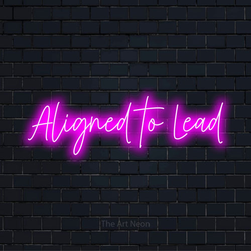 "Aligned To Lead" glowing LED neon sign on a black brick wall