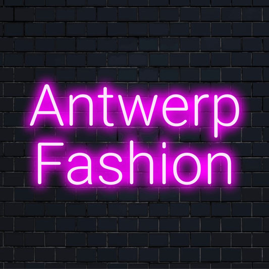 Antwerp Fashion Neon Light with neon text light on dark brick wall