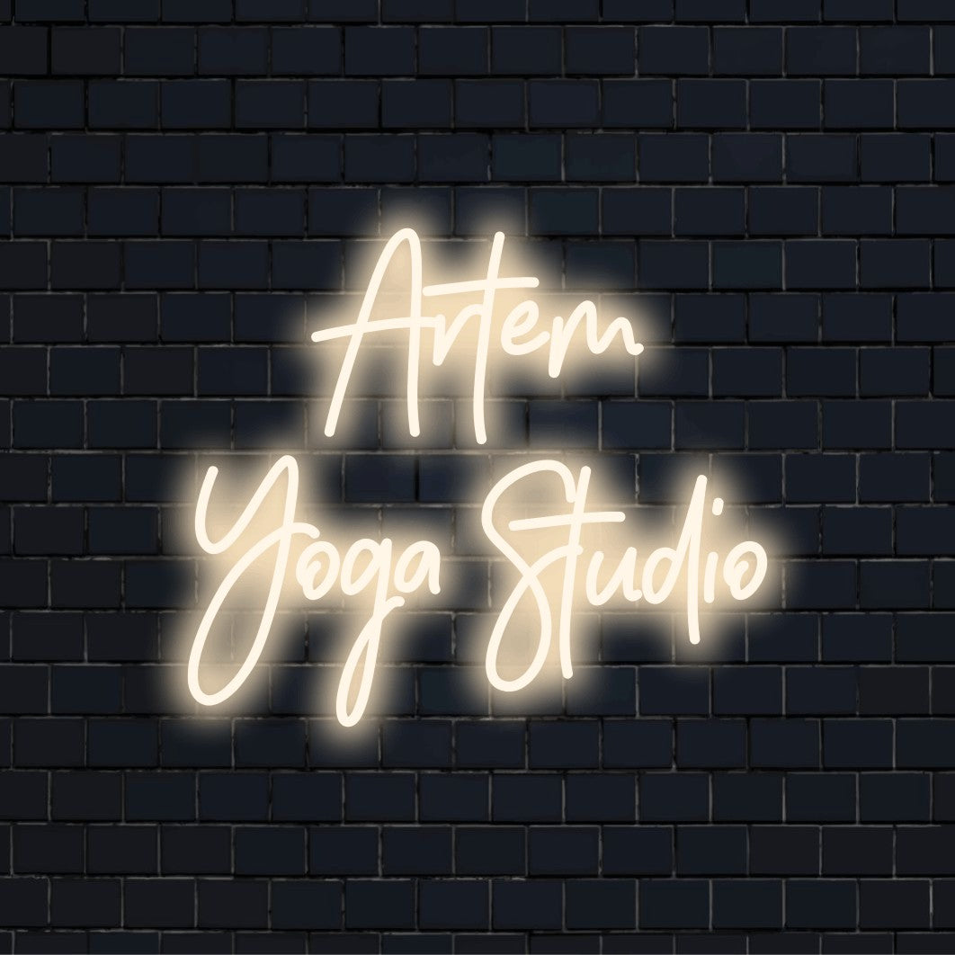 Artem Yoga Studio Personalized LED Neon Sign, bright neon glow against brick backdrop