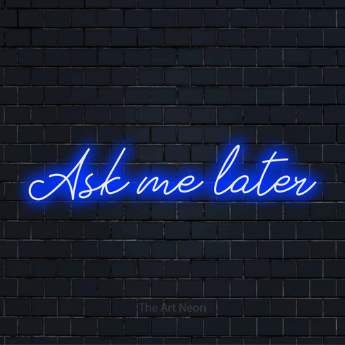 "Ask Me Later" neon text design on a black brick wall