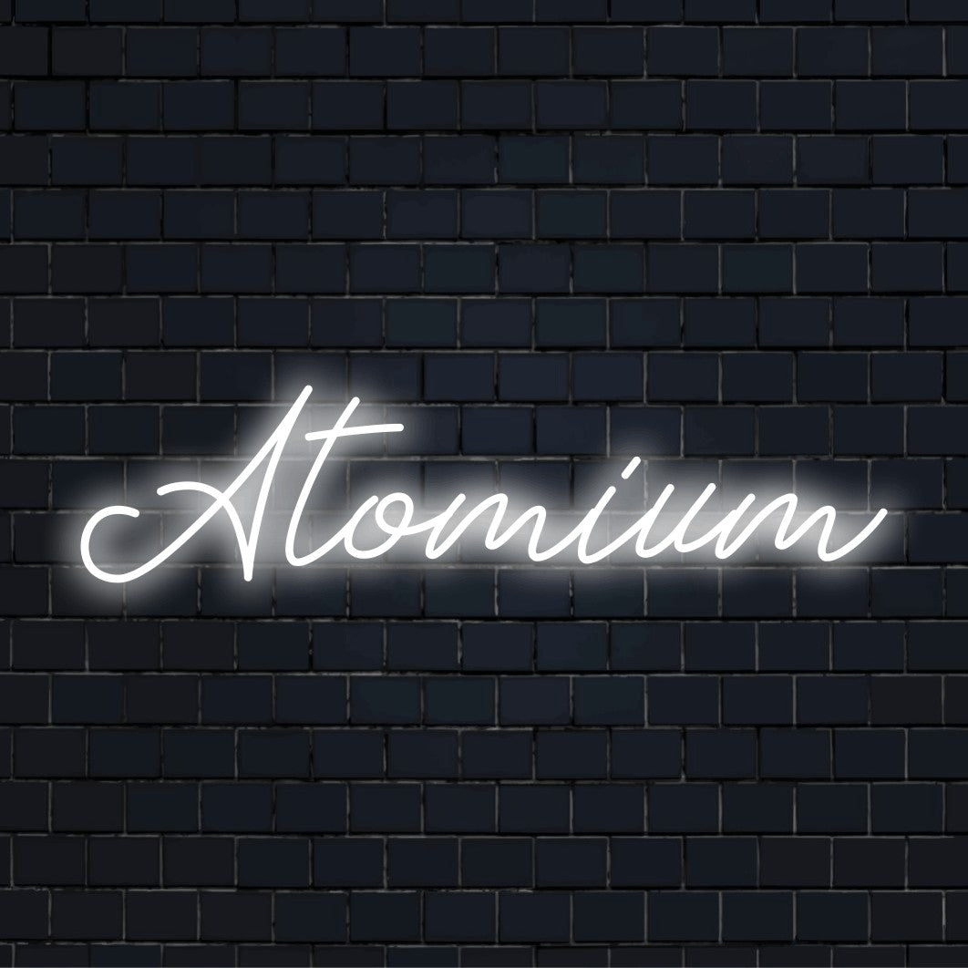Atomium Neon Sign, glowing neon text on dark brick wall
