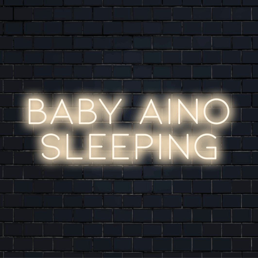 Baby Aino Sleeping Personalized LED Neon Sign, soft neon glow against brick backdrop