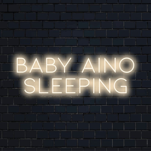 Baby Aino Sleeping Personalized LED Neon Sign, soft neon glow against brick backdrop