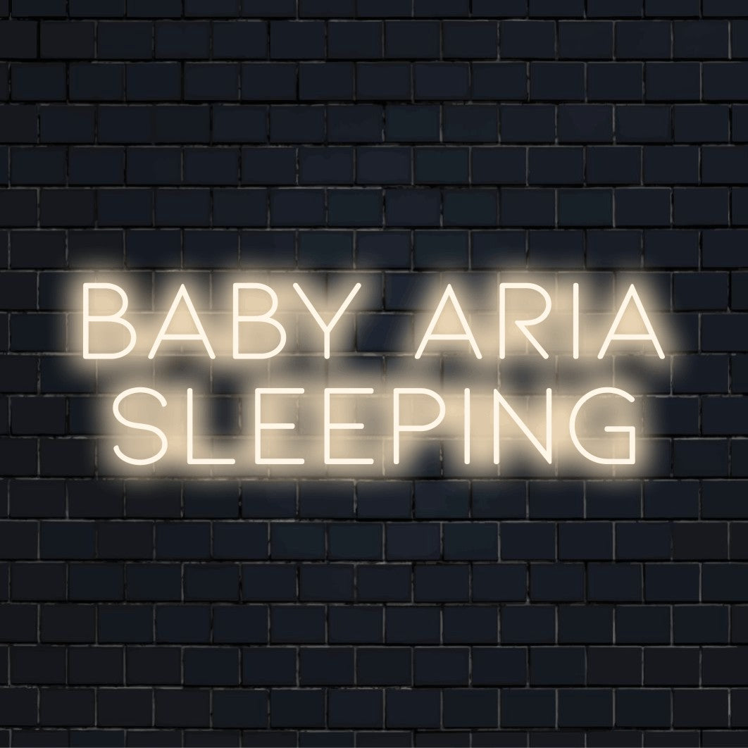 Baby Aria Sleeping Personalized LED Neon Sign, bright neon glow against brick backdrop