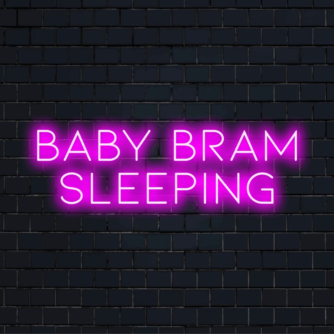 Baby Bram Sleeping Personalized LED Neon Sign, soft neon glow against black brick wall