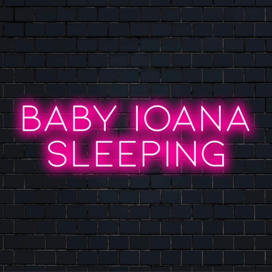 Baby Ioana Sleeping Personalized LED Neon Sign, bright neon glow on dark brick wall