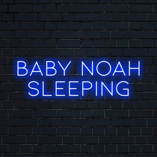 Baby Noah Sleeping Custom Name Neon Sign, glowing neon text against black brick wall