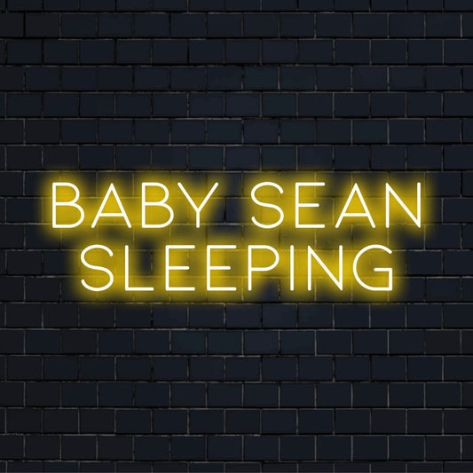 Baby Sean Sleeping Custom Name Neon Sign, bright neon glow on dark brick background