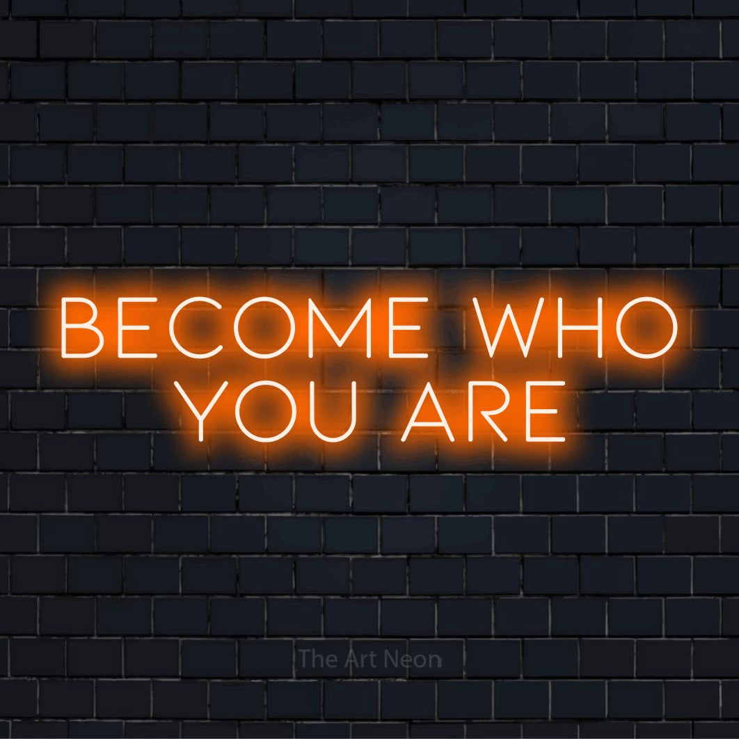 "Become Who You Are" neon text design on a black brick wall
